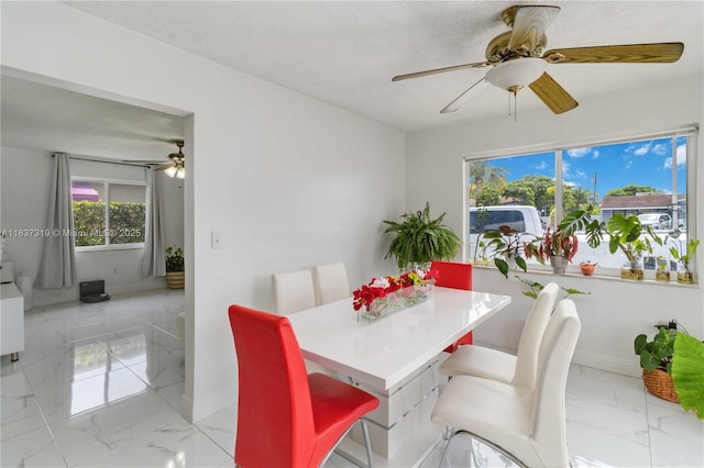 231 E 41st St, Hialeah, FL 33013 - dining space with ceiling fan, light marble finish floors, and healthy amount of natural light
