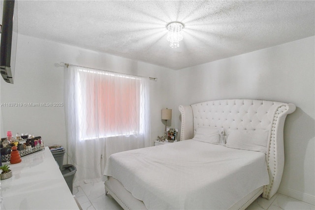 231 E 41st St, Hialeah, FL 33013 - bedroom with light marble finish floors and a textured ceiling