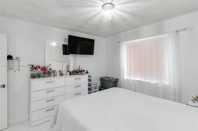 231 E 41st St, Hialeah, FL 33013 - bedroom with light marble finish floors and a textured ceiling