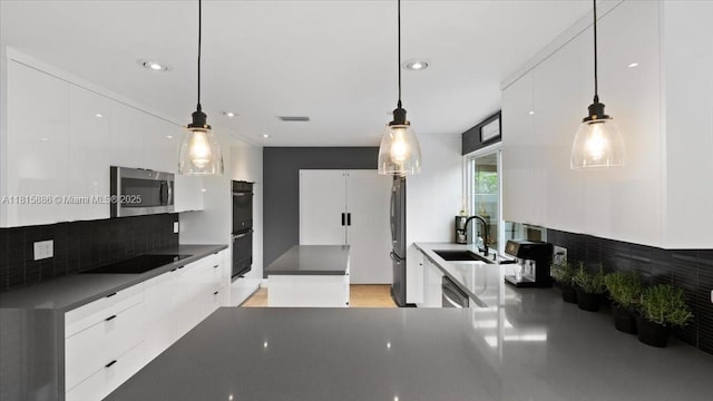 18701 Shauna Manor Dr, Boca Raton, FL 33496 - kitchen with appliances with stainless steel finishes, modern cabinets, decorative backsplash, white cabinetry, and recessed lighting