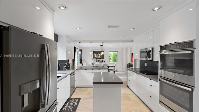 18701 Shauna Manor Dr, Boca Raton, FL 33496 - kitchen with appliances with stainless steel finishes, modern cabinets, white cabinets, and recessed lighting