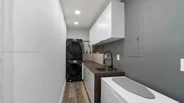 18701 Shauna Manor Dr, Boca Raton, FL 33496 - laundry room with stacked washer / drying machine, light wood-type flooring, and recessed lighting
