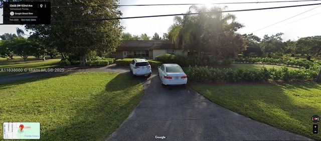 23595 SW 152nd Ave, Homestead, FL 33032 - view of front of house with driveway and a front lawn