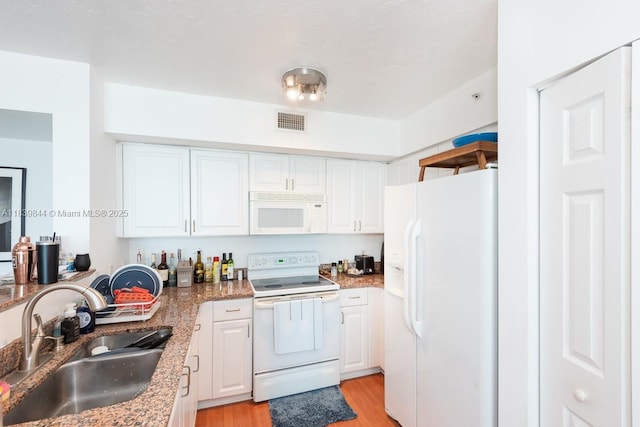 1155 Brickell Bay Dr Unit 3403, Miami, FL 33131 - kitchen featuring white appliances, white cabinetry, light wood-style flooring, and stone counters