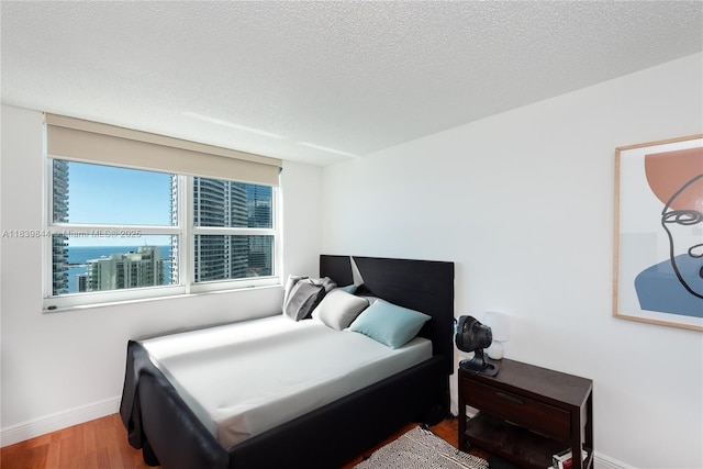 1155 Brickell Bay Dr Unit 3403, Miami, FL 33131 - bedroom with baseboards and wood finished floors