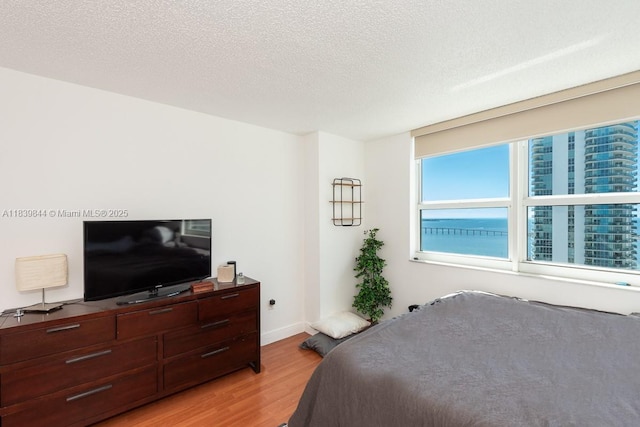 1155 Brickell Bay Dr Unit 3403, Miami, FL 33131 - bedroom with light wood-type flooring and a textured ceiling