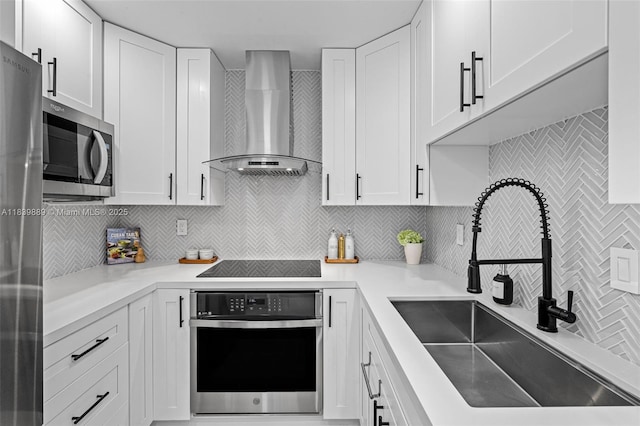 20379 W Country Club Dr Unit Ph38, Aventura, FL 33180 - kitchen with appliances with stainless steel finishes, wall chimney range hood, backsplash, white cabinetry, and light countertops