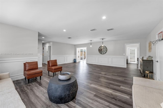 13305 SW 22nd Ter, Miami, FL 33175 - living room with dark wood-type flooring, recessed lighting, a decorative wall, a wood stove, and wainscoting