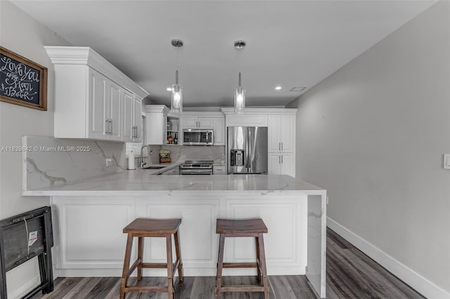 13305 SW 22nd Ter, Miami, FL 33175 - kitchen with appliances with stainless steel finishes, tasteful backsplash, a peninsula, dark wood-type flooring, and recessed lighting