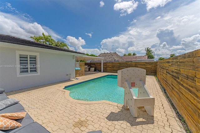 13305 SW 22nd Ter, Miami, FL 33175 - view of swimming pool featuring a patio area and a fenced backyard