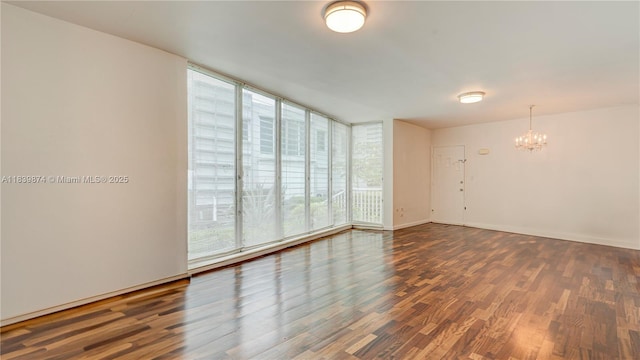 10178 Collins Ave Unit 102, Bal Harbour, FL 33154 - unfurnished room featuring a chandelier, wood finished floors, and a wall of windows