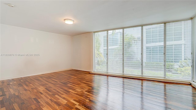 10178 Collins Ave Unit 102, Bal Harbour, FL 33154 - spare room featuring wood finished floors, a smoke detector, and a wall of windows