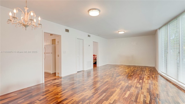 10178 Collins Ave Unit 102, Bal Harbour, FL 33154 - empty room with wood finished floors and a chandelier