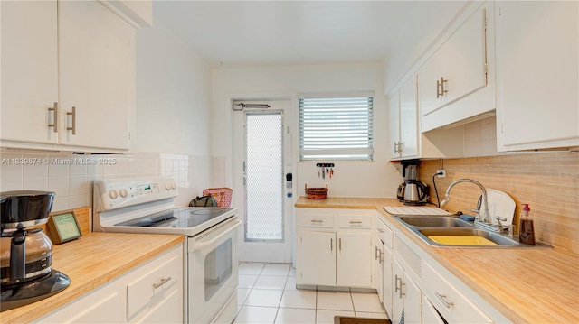 10178 Collins Ave Unit 102, Bal Harbour, FL 33154 - kitchen with electric range, light tile patterned floors, light countertops, and tasteful backsplash