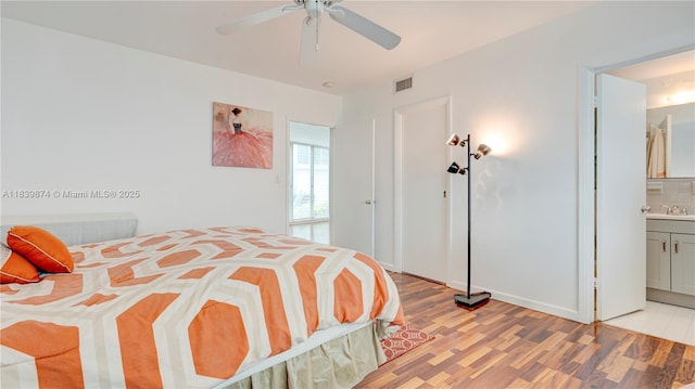 10178 Collins Ave Unit 102, Bal Harbour, FL 33154 - bedroom featuring light wood finished floors, connected bathroom, and ceiling fan