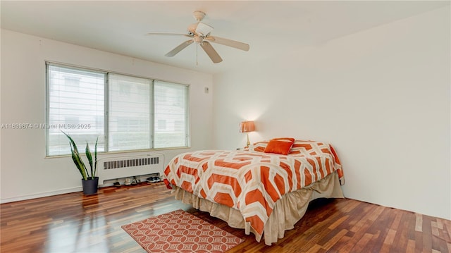 10178 Collins Ave Unit 102, Bal Harbour, FL 33154 - bedroom with radiator heating unit, wood finished floors, and a ceiling fan