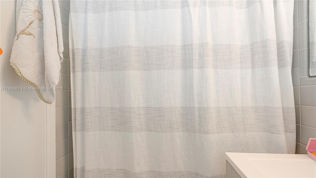 10178 Collins Ave Unit 102, Bal Harbour, FL 33154 - bathroom with vanity and a shower with curtain