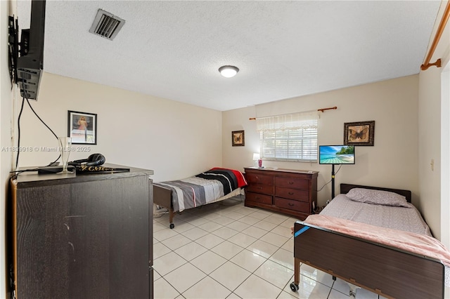 14213 SW 100th Ln, Miami, FL 33186 - bedroom featuring light tile patterned floors and a textured ceiling