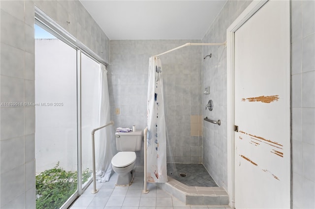14213 SW 100th Ln, Miami, FL 33186 - bathroom featuring a shower stall, tile walls, and tile patterned flooring