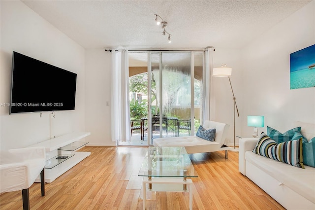 19701 E Country Club Dr Unit 5104, Aventura, FL 33180 - living room featuring wood finished floors, a textured ceiling, and floor to ceiling windows