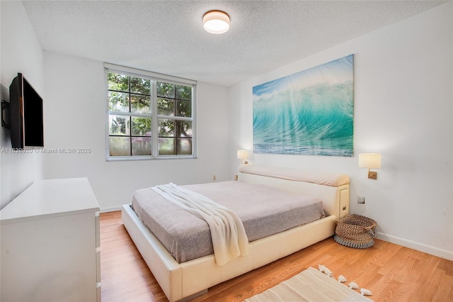 19701 E Country Club Dr Unit 5104, Aventura, FL 33180 - bedroom with a textured ceiling and wood finished floors