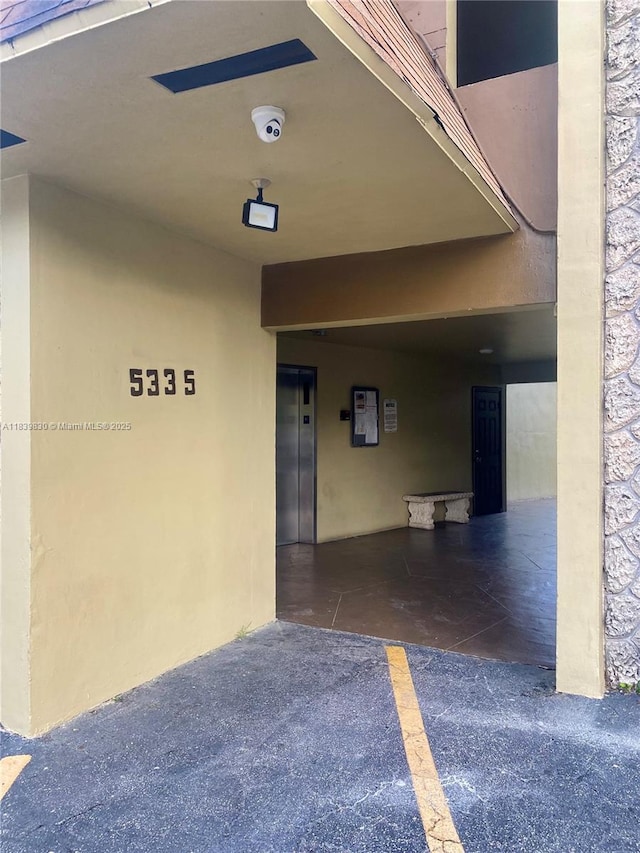 5335 NW 10th Ct Unit 208, Plantation, FL 33313 - doorway to property featuring elevator and a security system