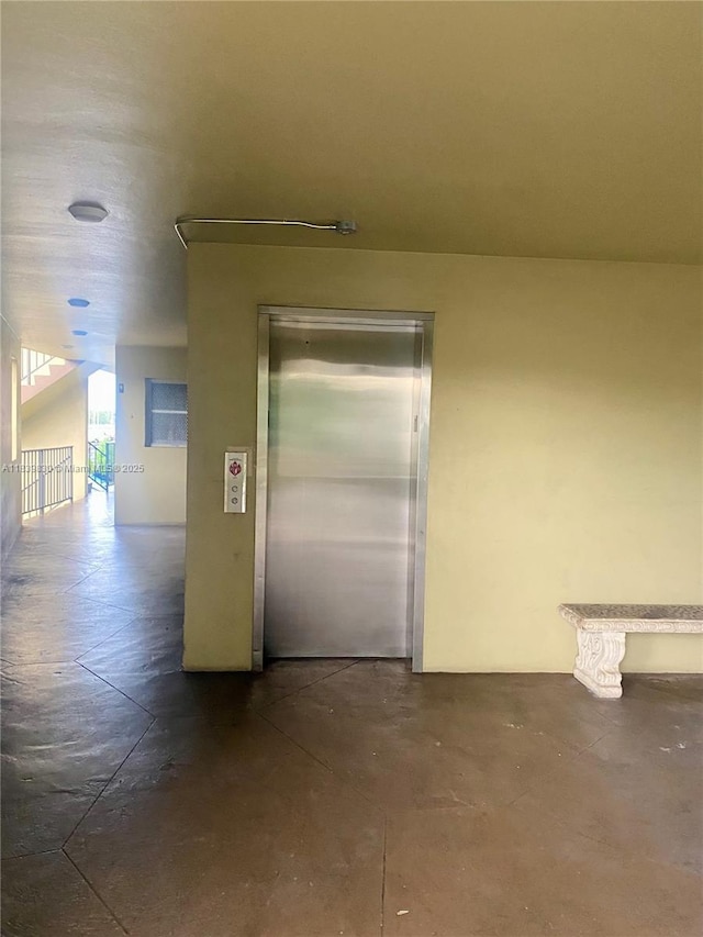 5335 NW 10th Ct Unit 208, Plantation, FL 33313 - hallway featuring elevator and concrete flooring