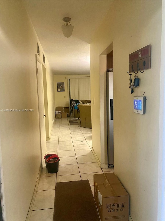 5335 NW 10th Ct Unit 208, Plantation, FL 33313 - hallway with light tile patterned flooring and baseboards