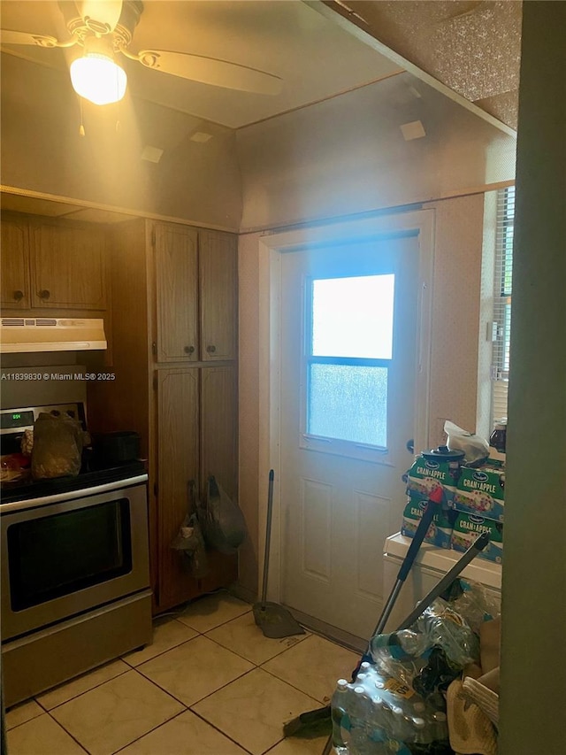 5335 NW 10th Ct Unit 208, Plantation, FL 33313 - kitchen featuring electric range, under cabinet range hood, light tile patterned flooring, and plenty of natural light