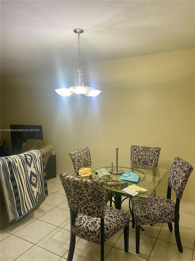 5335 NW 10th Ct Unit 208, Plantation, FL 33313 - dining room featuring light tile patterned floors and a textured ceiling