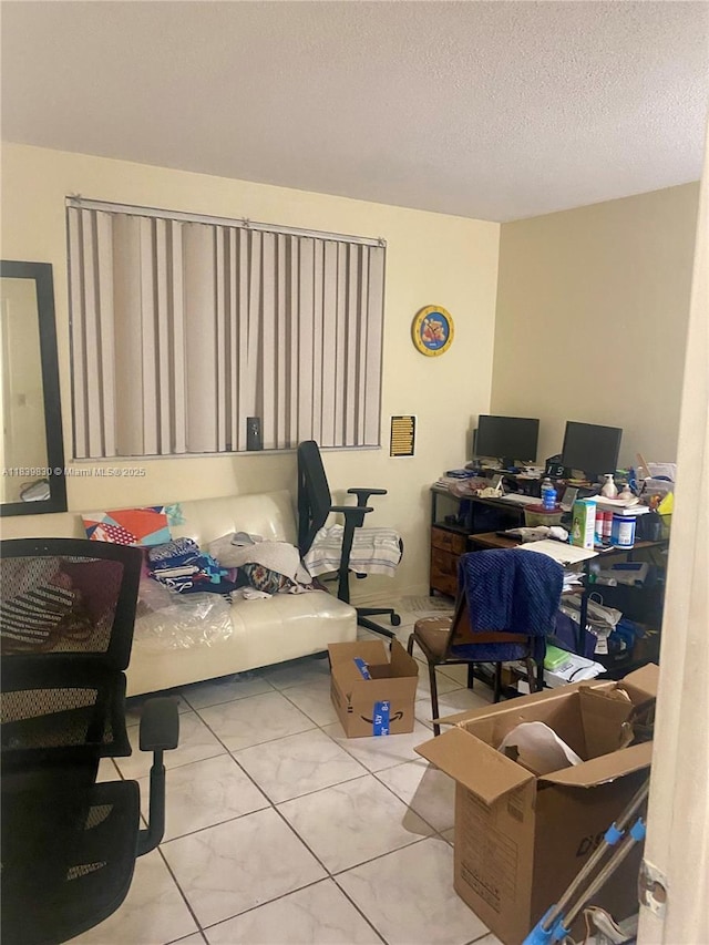 5335 NW 10th Ct Unit 208, Plantation, FL 33313 - bedroom with a desk, tile patterned floors, and a textured ceiling