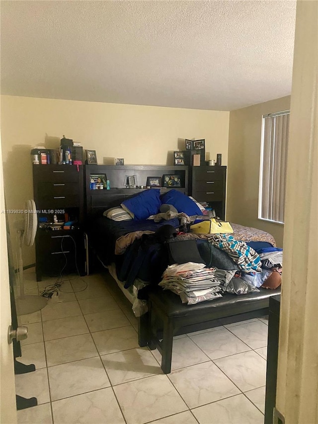 5335 NW 10th Ct Unit 208, Plantation, FL 33313 - bedroom with light tile patterned floors and a textured ceiling