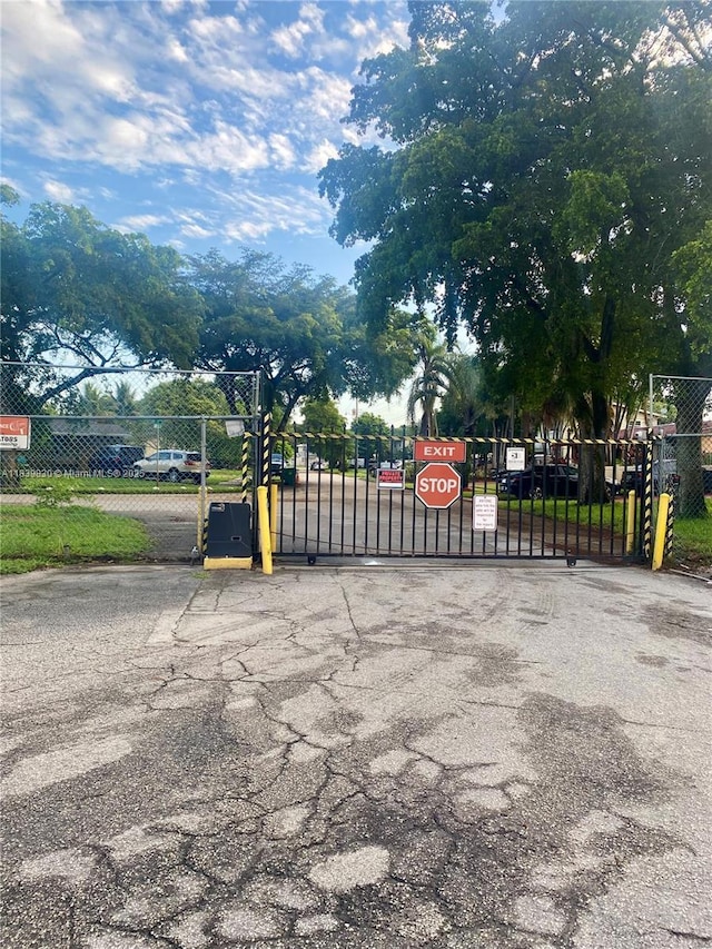 5335 NW 10th Ct Unit 208, Plantation, FL 33313 - view of asphalt road with a gate and a gated entry