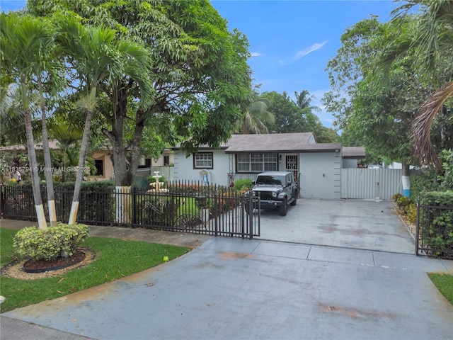 1340 NW 128th St, North Miami, FL 33167 - ranch-style home with driveway, a gate, stucco siding, and a fenced front yard