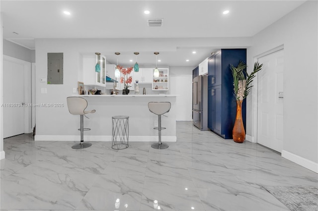 1340 NW 128th St, North Miami, FL 33167 - kitchen with high end fridge, electric panel, blue cabinets, light marble finish floors, and a breakfast bar area