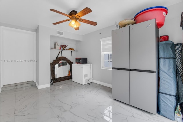 1340 NW 128th St, North Miami, FL 33167 - empty room featuring marble look tiles and ceiling fan