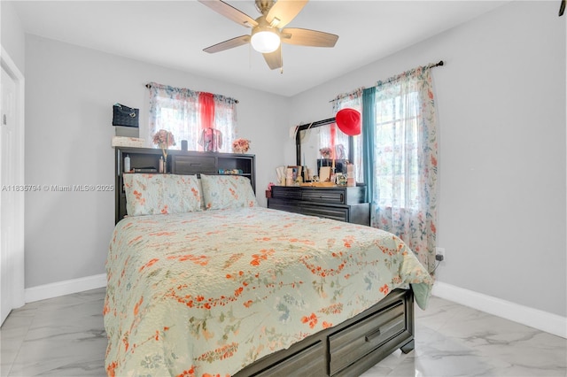 1340 NW 128th St, North Miami, FL 33167 - bedroom with light marble finish floors and a ceiling fan