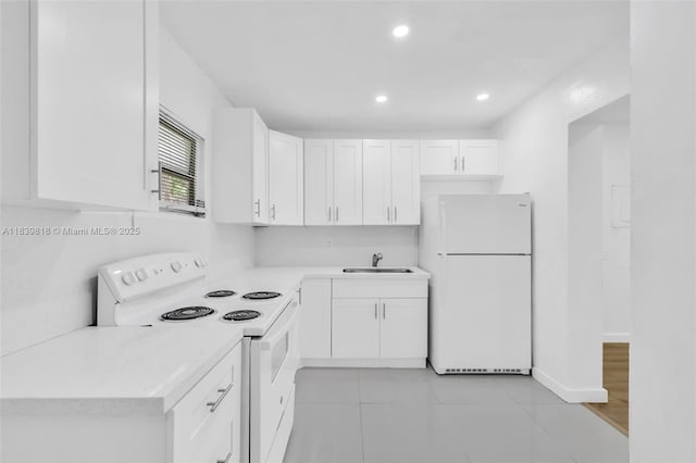 1315 NE 146th St, Miami, FL 33161 - kitchen with white appliances, light countertops, white cabinets, recessed lighting, and light tile patterned floors