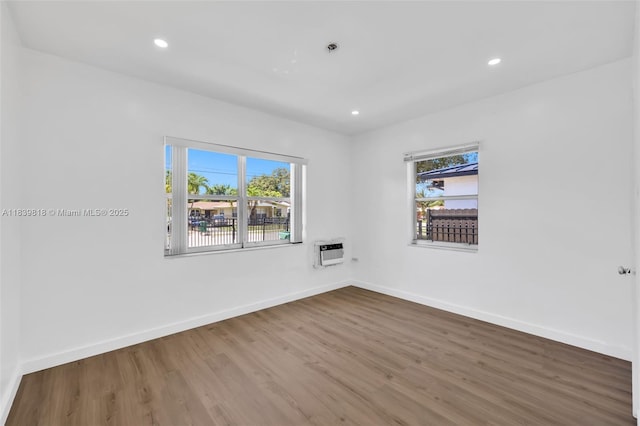 1315 NE 146th St, Miami, FL 33161 - spare room with plenty of natural light, wood finished floors, a wall mounted AC, and recessed lighting