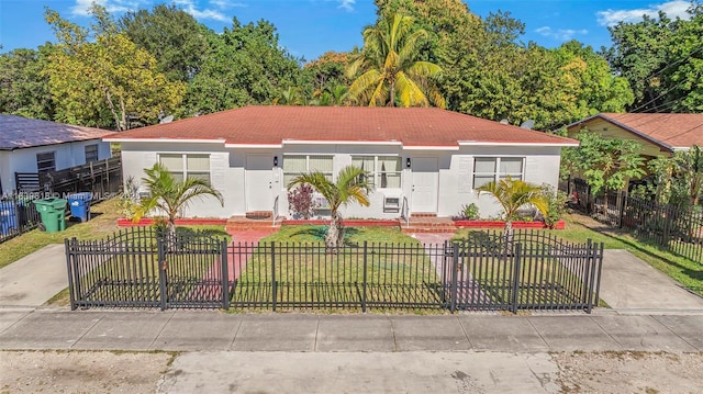 1315 NE 146th St, Miami, FL 33161 - view of front facade with a fenced front yard and stucco siding