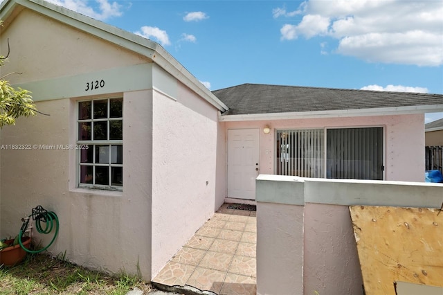 3120 NW 203rd Ter, Miami Gardens, FL 33056 - doorway to property with roof with shingles and stucco siding