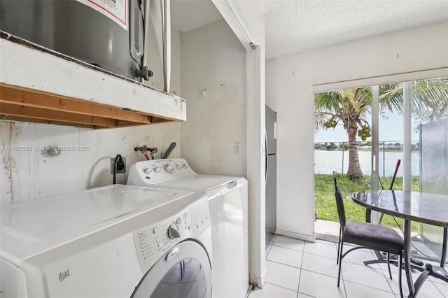 3120 NW 203rd Ter, Miami Gardens, FL 33056 - washroom with separate washer and dryer, light tile patterned floors, a water view, and a textured ceiling
