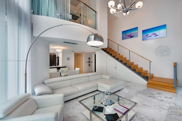 200 Biscayne Boulevard Way Unit 502, Miami, FL 33131 - living area featuring a towering ceiling, stairs, marble finish floors, and a chandelier