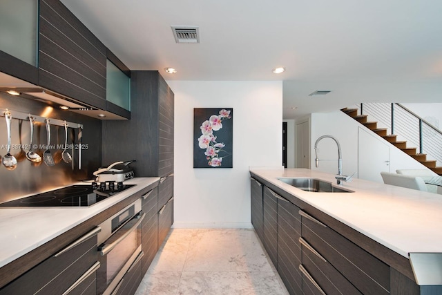 200 Biscayne Boulevard Way Unit 502, Miami, FL 33131 - kitchen with oven, black electric cooktop, light countertops, a peninsula, and recessed lighting