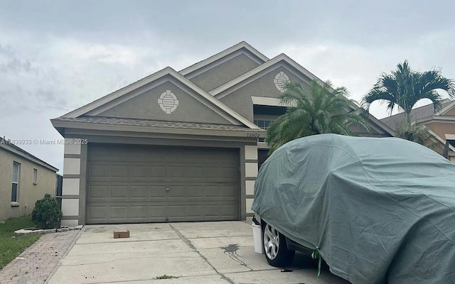 12603 Midpointe Dr, Riverview, FL 33578 - view of front of home with concrete driveway and stucco siding