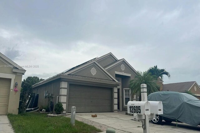 12603 Midpointe Dr, Riverview, FL 33578 - ranch-style home with driveway, a garage, and stucco siding