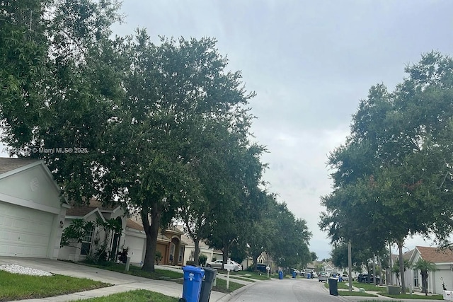 12603 Midpointe Dr, Riverview, FL 33578 - view of asphalt street with sidewalks, a residential view, and curbs