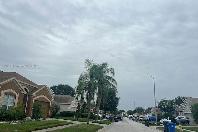 12603 Midpointe Dr, Riverview, FL 33578 - view of asphalt street featuring street lighting, sidewalks, curbs, and a residential view