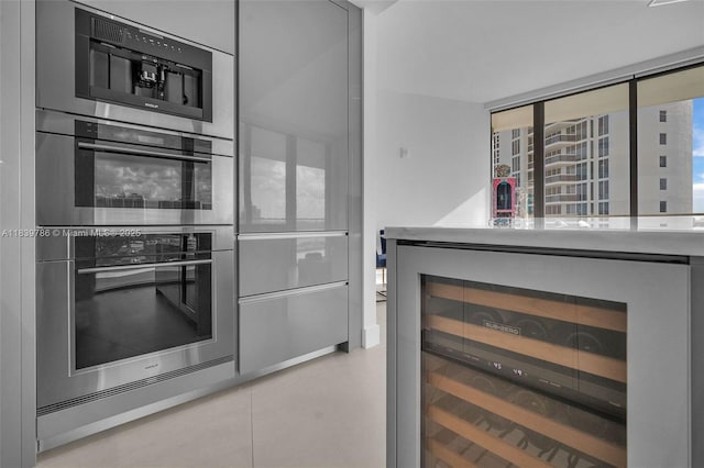 18975 Collins Ave Unit 1105, Sunny Isles Beach, FL 33160 - kitchen with beverage cooler, double oven, and light countertops
