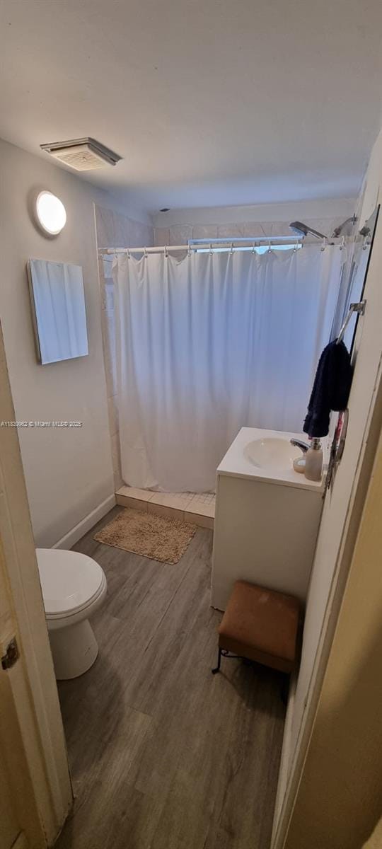 7230 NW 3rd St, Miami, FL 33126 - bathroom featuring wood finished floors, vanity, and a shower with curtain